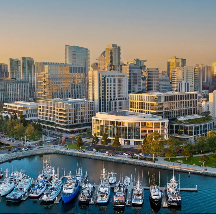 Waterfront life sciences development by IQHQ featuring modern laboratory buildings